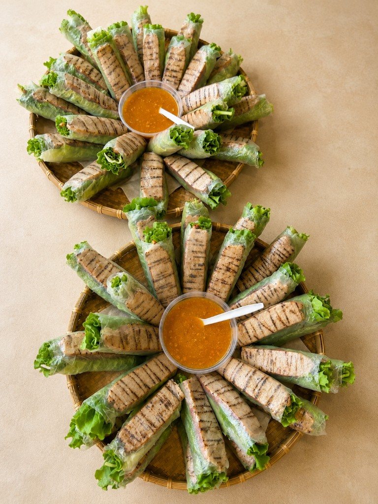 Grilled pork spring rolls on catering platters